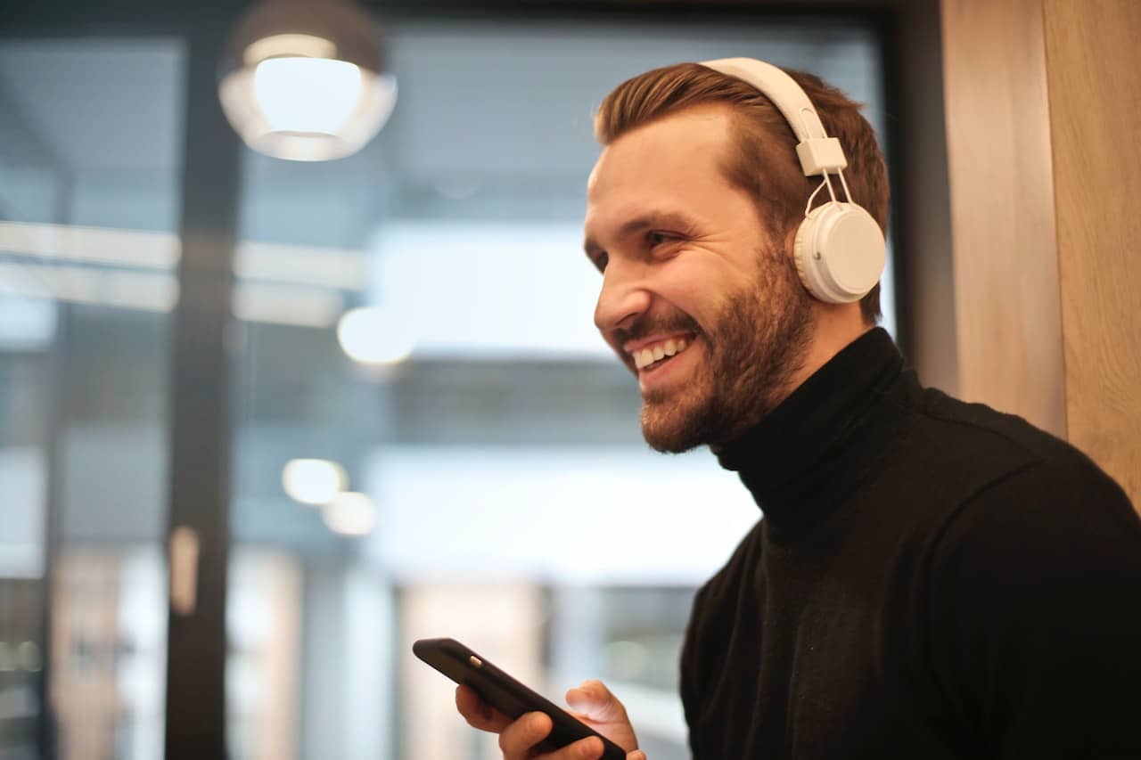 smiling person listening to headphones